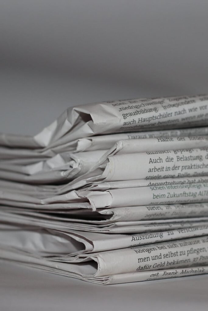 A close-up image of folded newspapers, perfect for news or journalism themes.